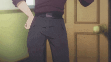 a man standing in front of a door with his hand on his hip