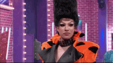 a drag queen wearing a flintstones costume and a necklace