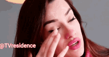 a woman with red hair and pink lips is applying makeup to her face ..