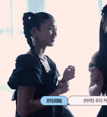 a woman in a black dress with the name hyojung written on a blue button