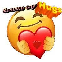 a smiley face is holding a red heart with the words sending gay hugs above it