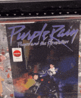 a purple rain album cover with a man on a motorcycle on it