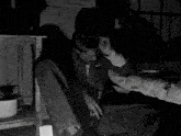 a black and white photo of a man laying on the floor
