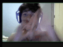 a blurry picture of a man wearing headphones