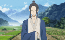 a man in a blue and white robe is standing in a field