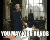 a man in a military uniform is standing in front of a window with the words `` you may kiss hands '' written on the screen .