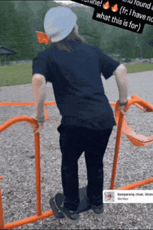 a man in a black shirt is standing on a playground with a sticker that says what this is for