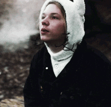 a person wearing a furry hat with ears and a black jacket