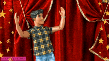 a barbie doll is dancing in front of a red curtain with a purple sticker that says nyferrystuff on it