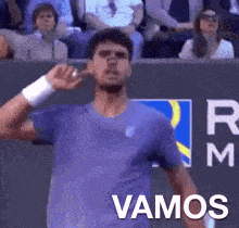 a man in a purple shirt with the word vamos written on the bottom