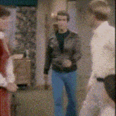 a group of people are standing in a room talking