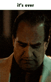 a close up of a man 's face with the words it 's over below him