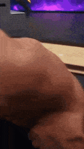 a person 's arm is shown in a blurry photo with a purple background