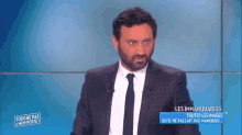 a man in a suit and tie is on a television show called touche pas mon poste