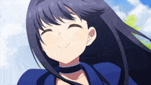 a girl with long dark hair is smiling and wearing a blue dress