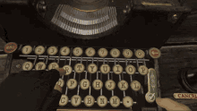 a person is typing on an old typewriter with a cancel button on the bottom