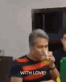a man is drinking a glass of beer with the words with love written below him .