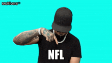 a man wearing a hat and a necklace with the word nfl on it