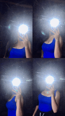 a woman in a blue tank top is taking a selfie with her phone