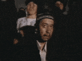 a man wearing a hat is talking on a phone
