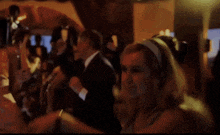 a woman in a blue dress is dancing with a man