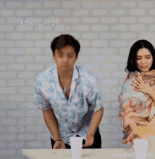 a man and a woman are playing a game of cornstarch on march 26