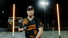 a baseball player wearing a black jersey with the number 21
