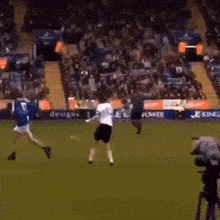 a soccer game is being played in front of a king ad