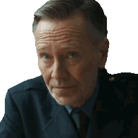 a man in a suit and tie looks at the camera with a serious look on his face