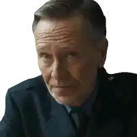 a man in a suit and tie looks at the camera with a serious look on his face