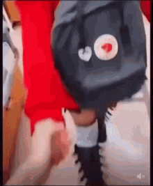a person is holding another person 's hand while walking with a backpack .