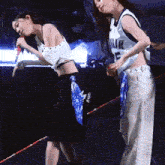 a woman in a white jersey with the number 5 on it is standing next to another woman