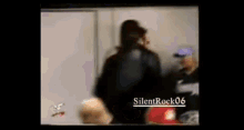 a blurry picture of a man talking on a cell phone with the words silentrock06 on the bottom .