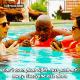 a group of people are swimming in a pool and one of them is holding a drink in his mouth .