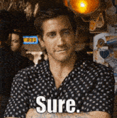 a man in a black polka dot shirt says sure in white letters