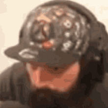 a blurry picture of a man wearing headphones and a hat with the letter g on it