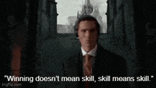 a man in a suit and tie is talking about winning does n't mean skill .
