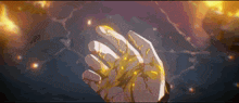 a close up of a person 's hand with a yellow substance coming out of it .