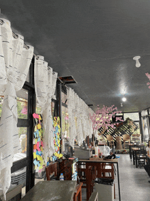 the inside of a restaurant with tables and chairs and sticky notes on the wall
