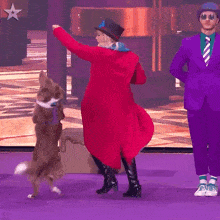a woman in a red coat is dancing with a brown dog