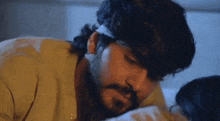 a man with a bandaged head is kissing a woman on the forehead .