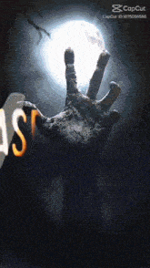 a hand is reaching out in front of a full moon with a caption that says " capcut "