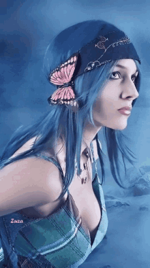a woman with blue hair is wearing a bandana with a butterfly on her head