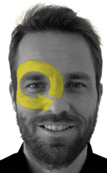 a man with a beard has a yellow circle painted on his eye