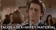 a man in a suit and tie is making a funny face while talking about tacos and sex .