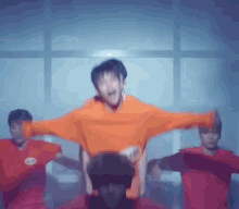 a group of young men are dancing in a dark room .