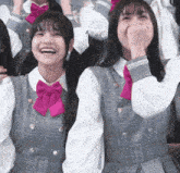 a girl wearing a pink bow tie is laughing