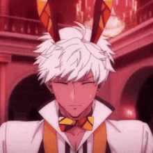 a man with white hair and bunny ears is wearing a bow tie and a white shirt .