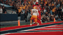 a football player wearing a jersey with the number 20 on it runs towards another player wearing a jersey with the number 83 on it