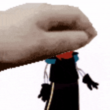 a hand is holding a bottle opener over a toy figure .